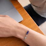 Person wearing a bracelet with blue beads 