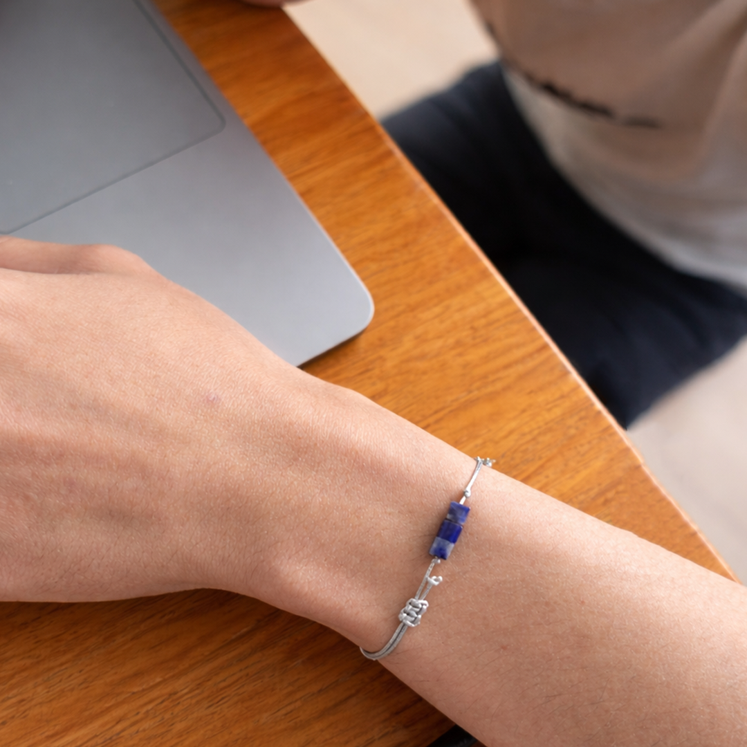Person wearing a bracelet with blue beads 