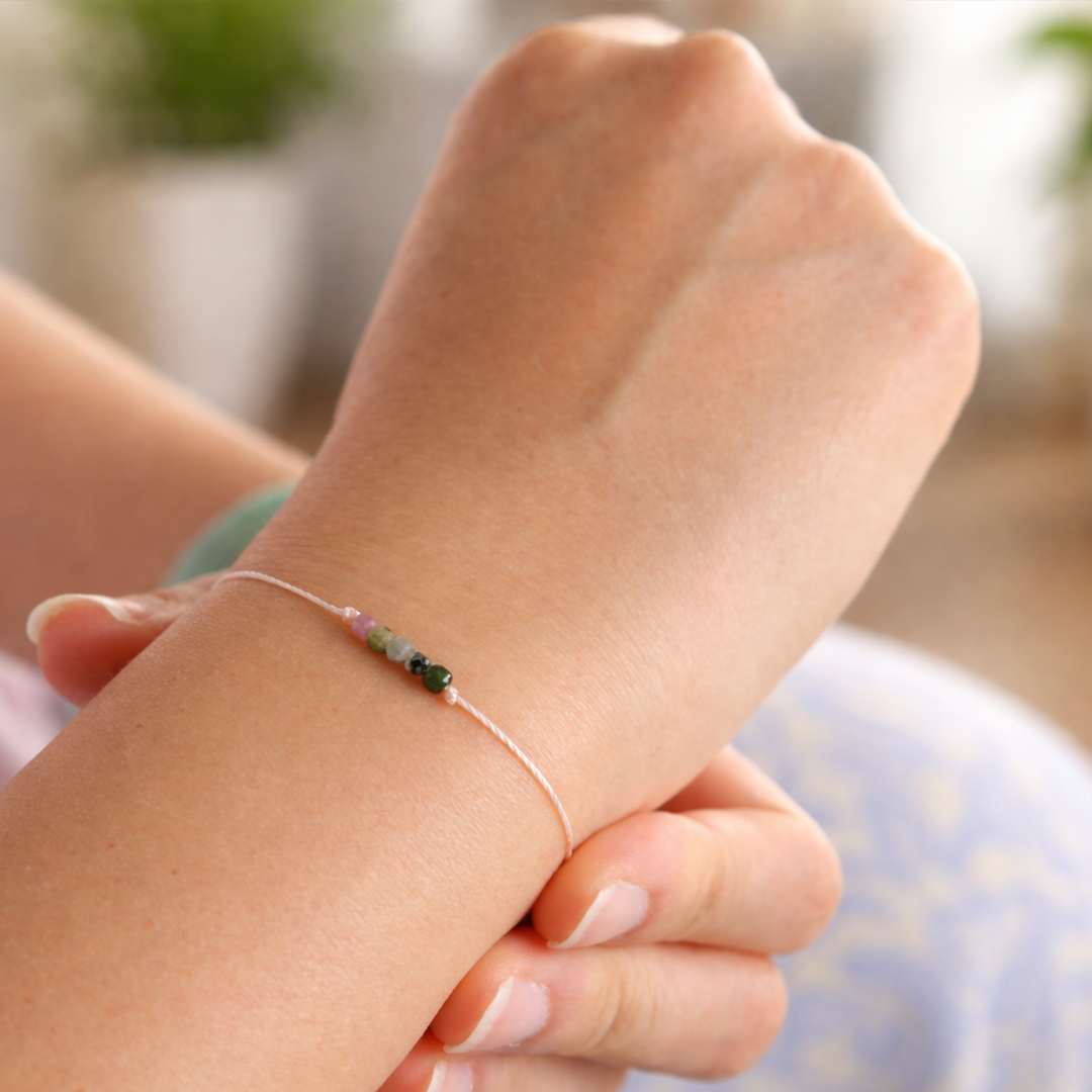 Close-up of a hand wearing a delicate beads bracelet 