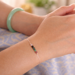 Close up of a wrist wearing a bracelet with colorful beads 