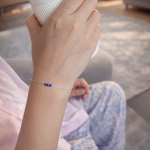 Hand wearing a bracelet with blue beads