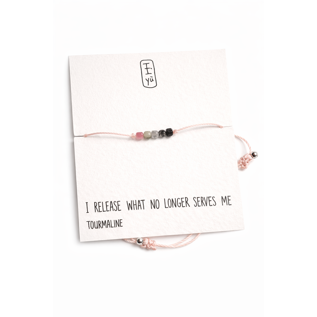 Bracelet with tourmaline beads on a card with text