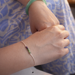 Close up of a person wrist wearing a bracelet with small beads 