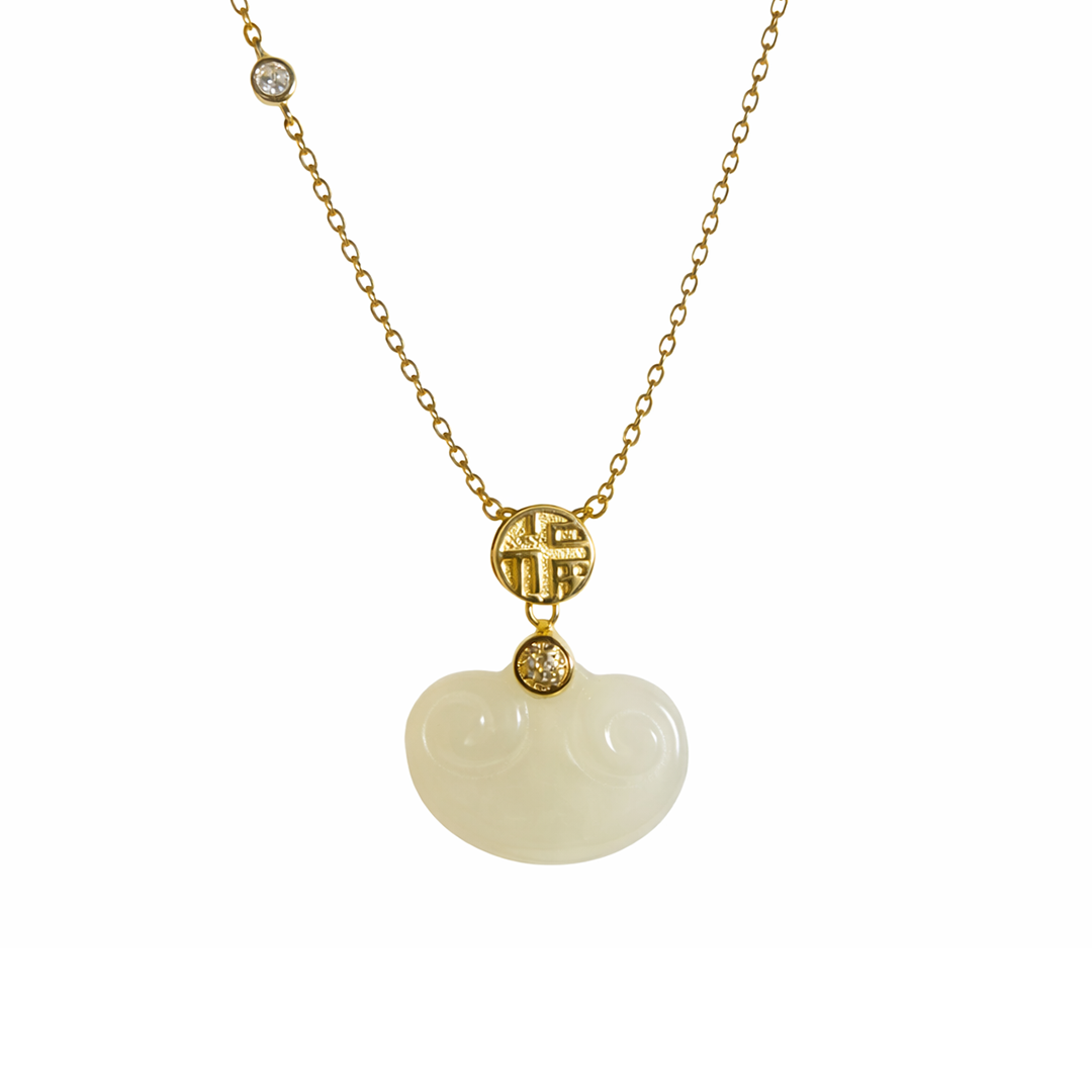Necklace with a gold plated sterling silver chain, white pendant