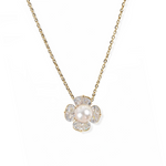 gold plated sterling silver necklace with a floral pendant featuring a pearl 