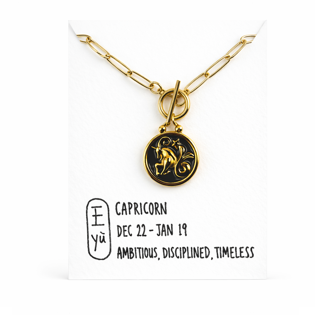 Gold plated necklace with a black pendant 