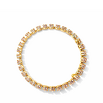 Celestial cuff  gold plated bracelet with gemstones on a white and light purple bracelet top down view