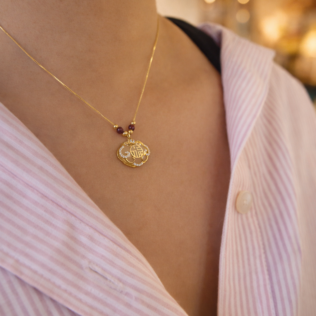 old plated necklace with a pendant on a person