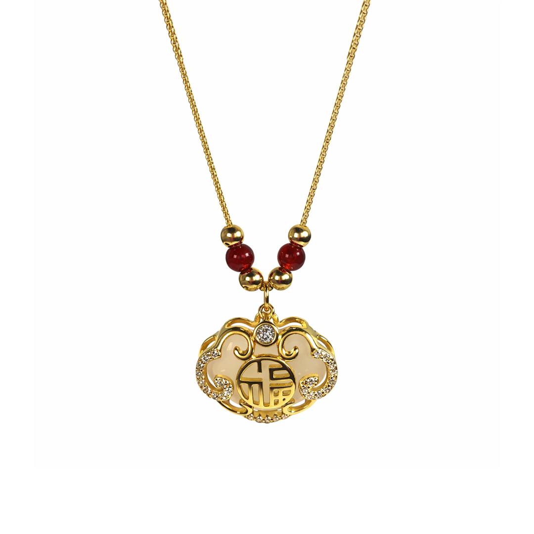 Gold plated sterling silver necklace with a heart-shaped pendant and red beads