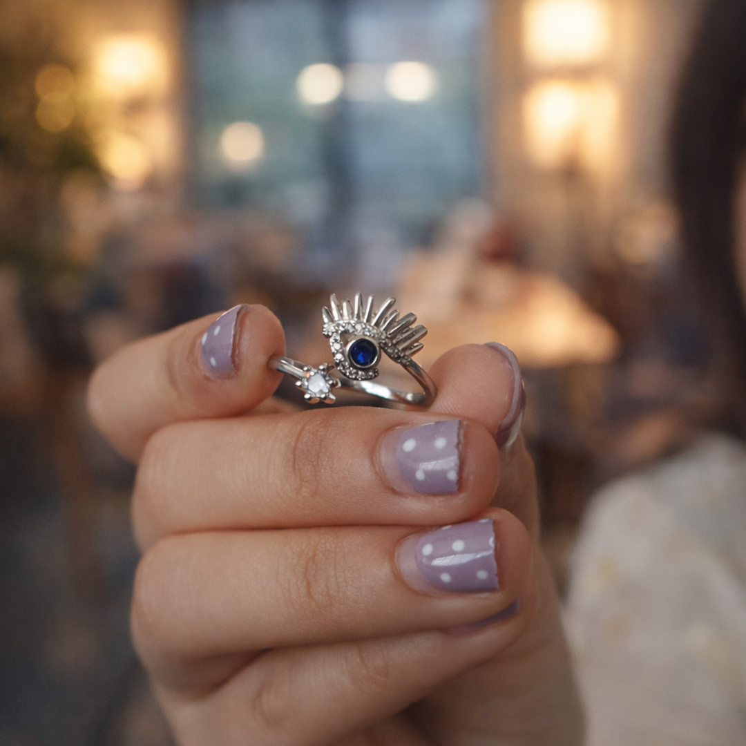 Close-up of a hand wearing a sterling silver ring with a blue gemstone 