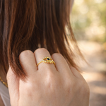 Close-up of a women hand wearing a gold  plated ring with an eye design