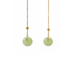 Halo is pair of green jade earrings with gold plated sterling silver chain