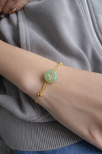 Woman wearing Ling’s Halo green jade bracelet in sterling silver