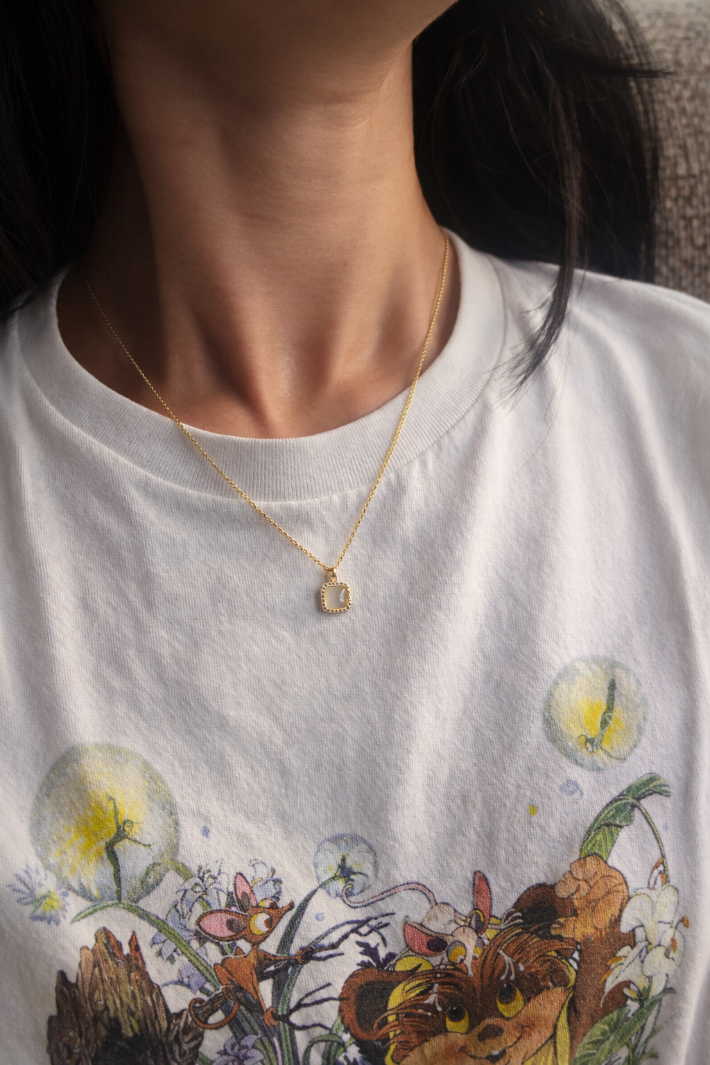 Person wearing Lunar legacy  a sterling silver gold plated square jade necklace