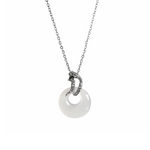 sterling silver necklace with a white circular pendant with a snake at top with green eyey