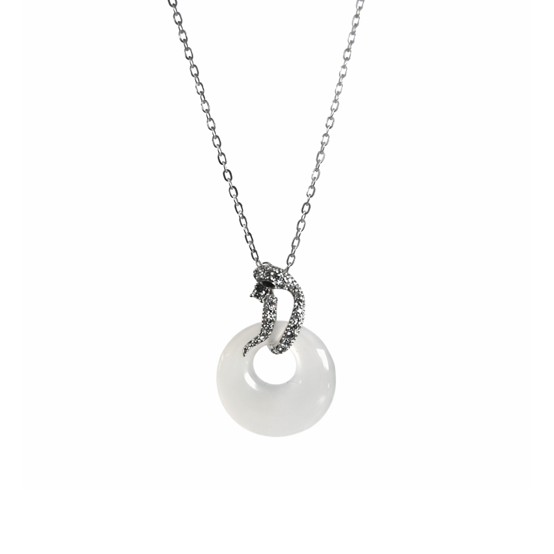 sterling silver necklace with a white circular pendant with a snake at top with green eyey