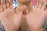 Gold plated necklace with a red pendant with fish design