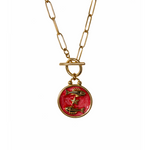 Gold plated resin necklace with a red pendant featuring fish illustrations 
