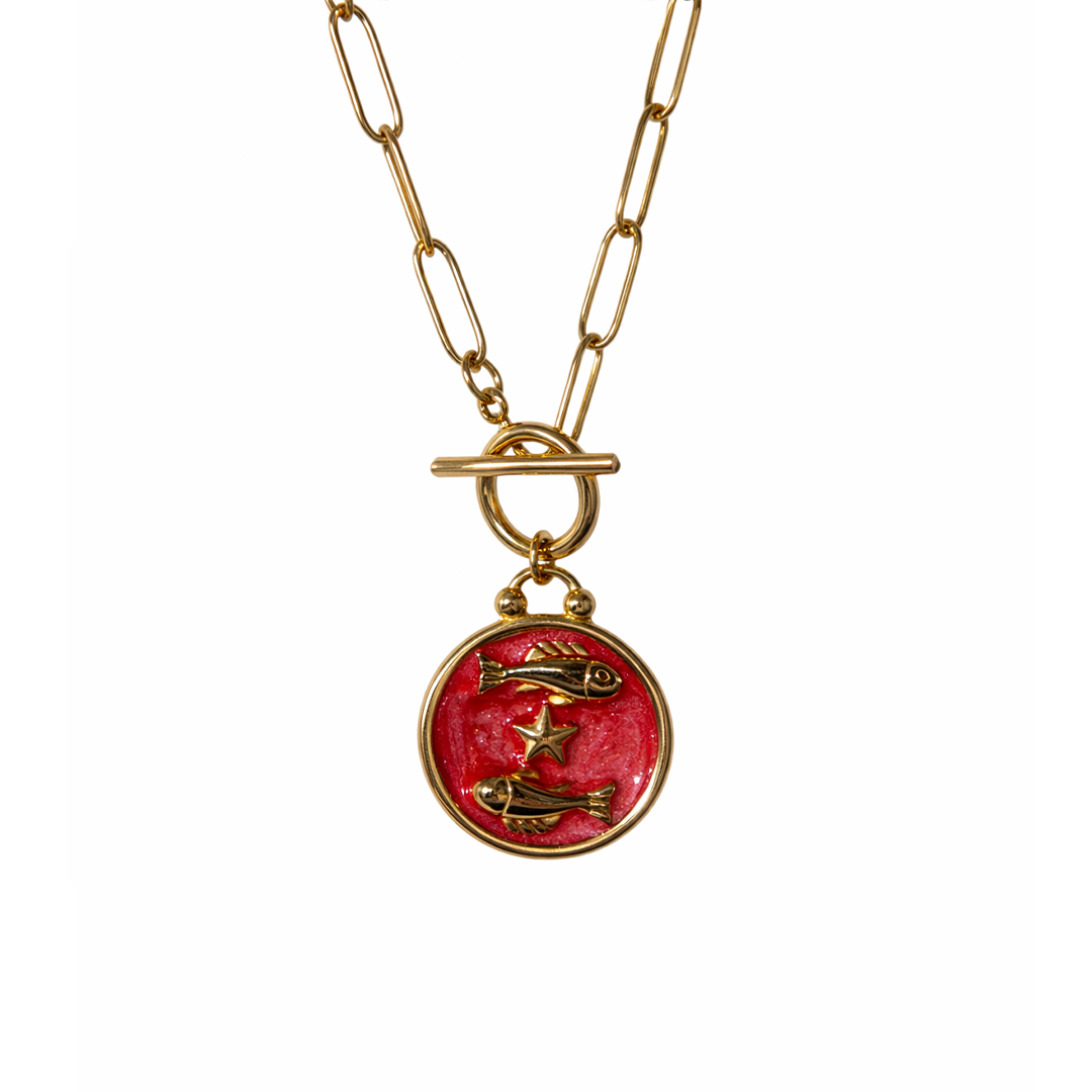 Gold plated resin necklace with a red pendant featuring fish illustrations 