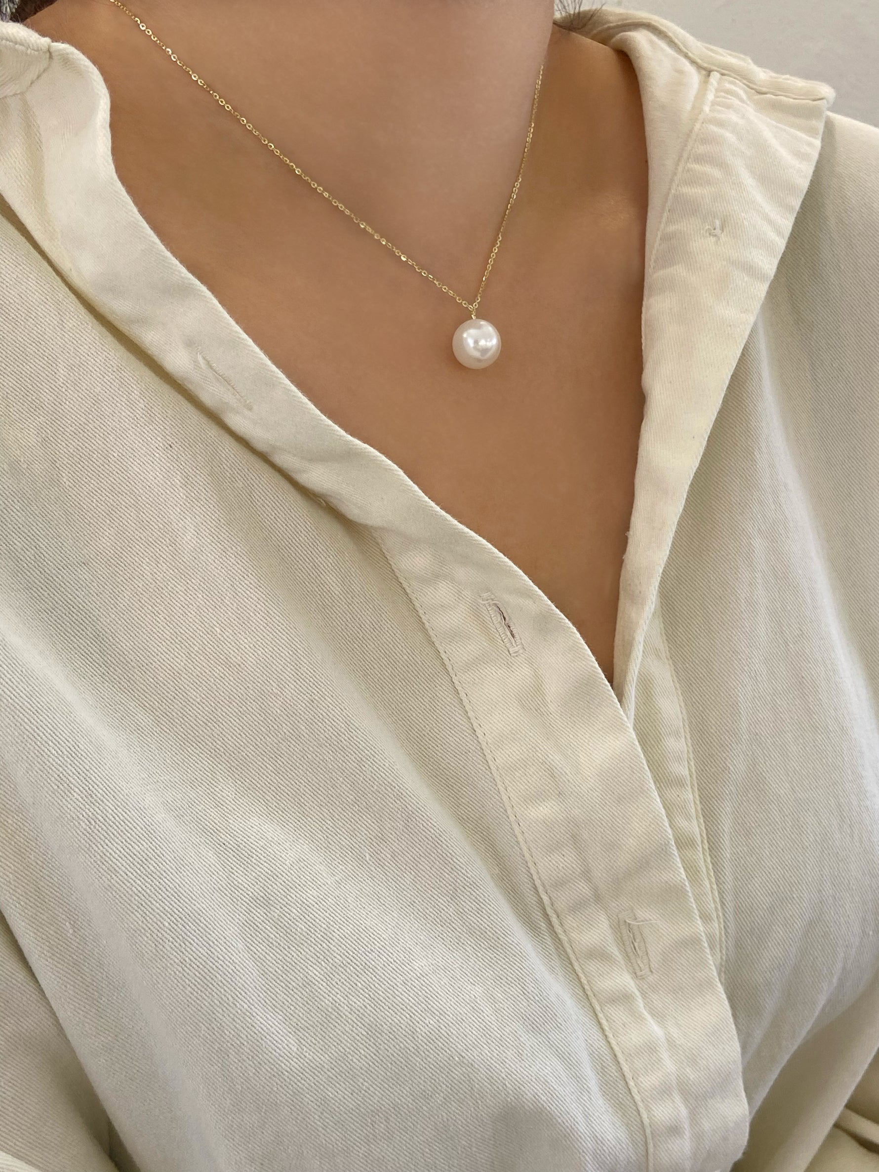 purity pearl necklace worn by a person 