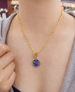 Sagittarius necklace women wearing gold plated stainless necklace with a blue pendant featuring a star and arrow design in resin