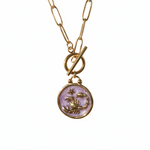 Necklace with a gold plated chain and a round pendant featuring a scorpion design 