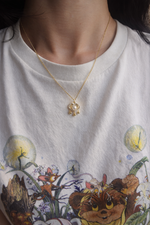 sterling silver gold plated pearl necklace with a pendant worn by a person 