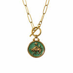 Gold plated necklace with a green pendant featuring a star and bull design 
